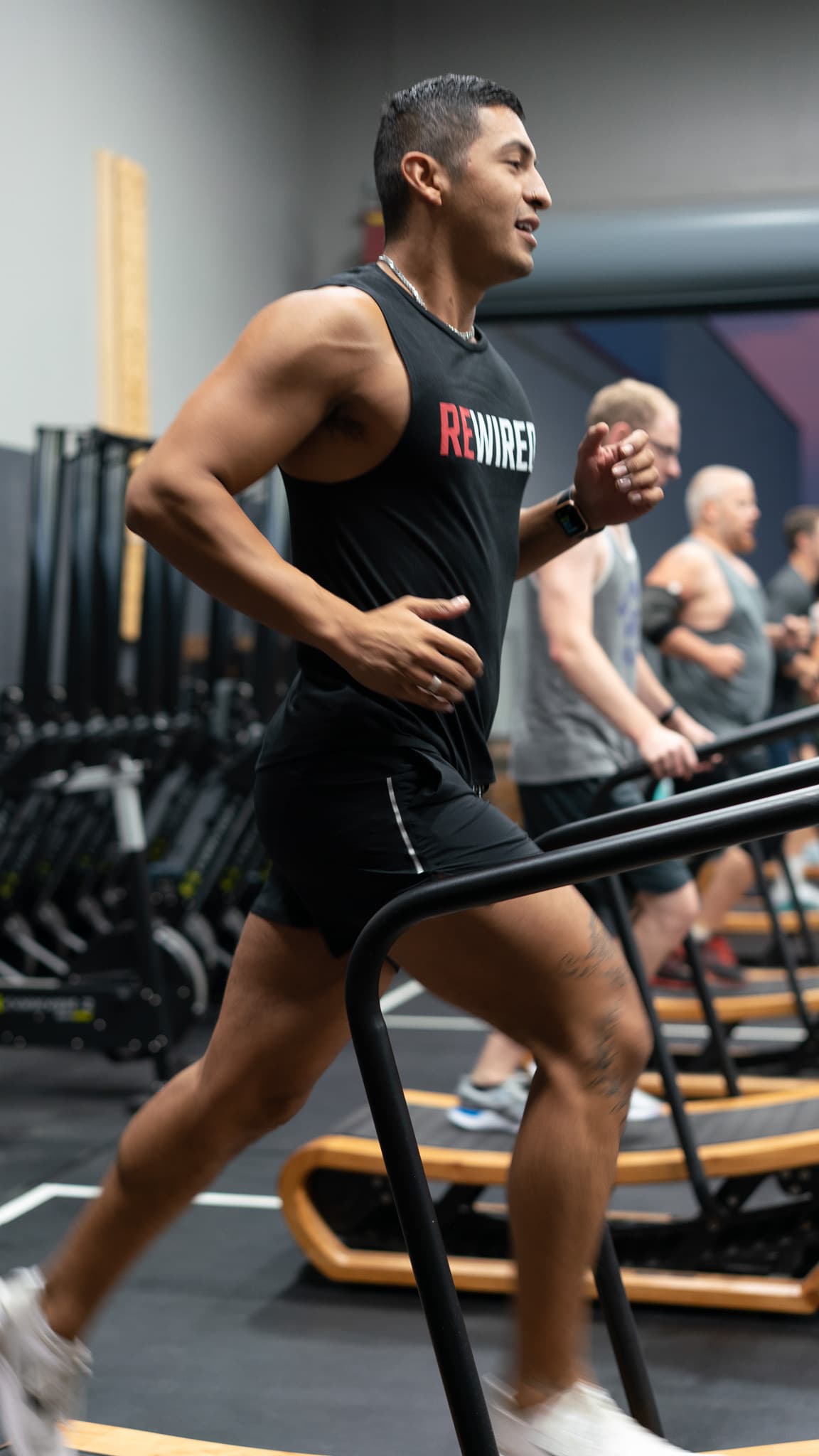 Member running on the treadmill during conditioning work at Rewired Fitness Co.